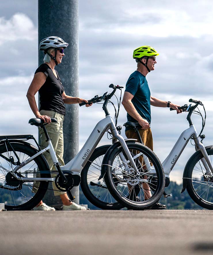 People Standing Next to Electric Bikes People Standing Next to Electric Bikes