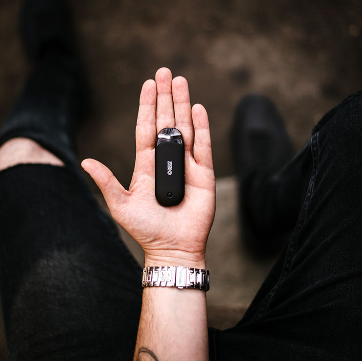 Person Holding Black Vape in Palm of Hand Person Holding Black Vape in Palm of Hand